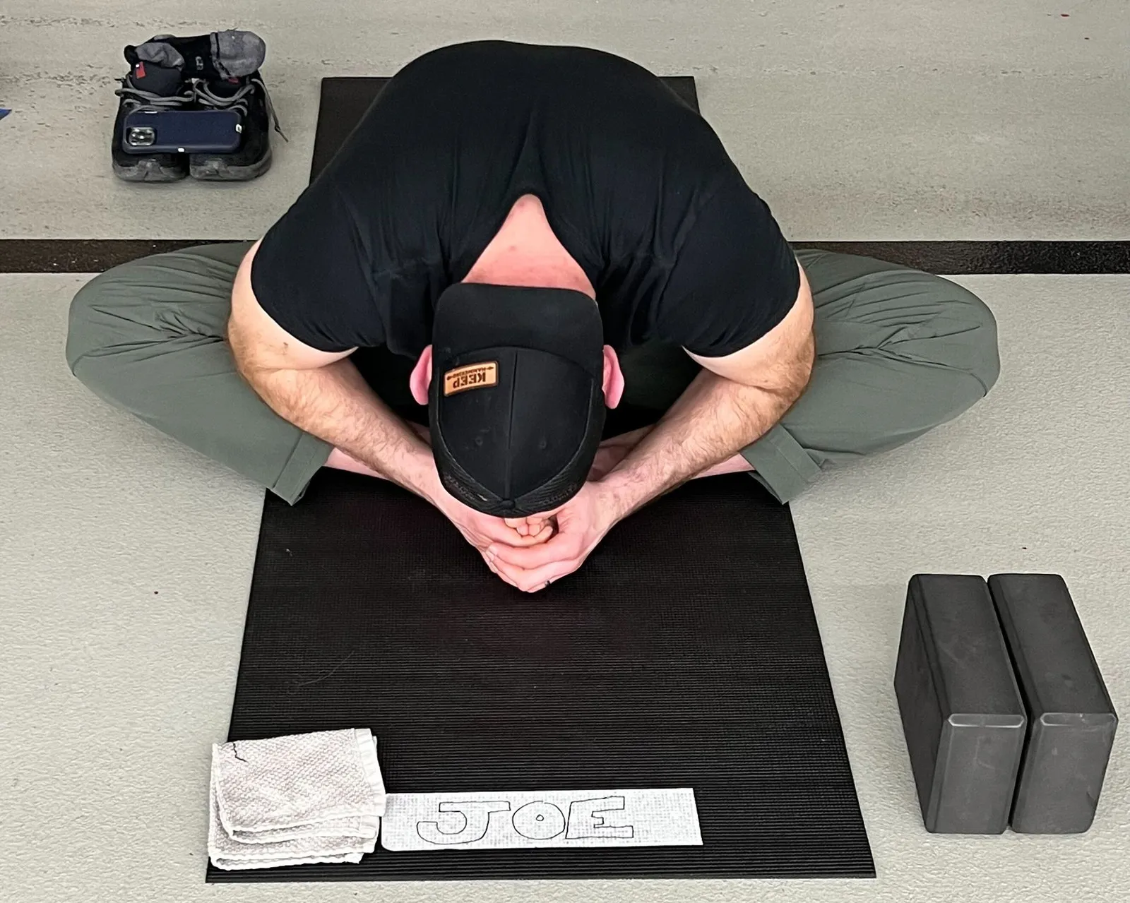 Man with hat practicing yoga.